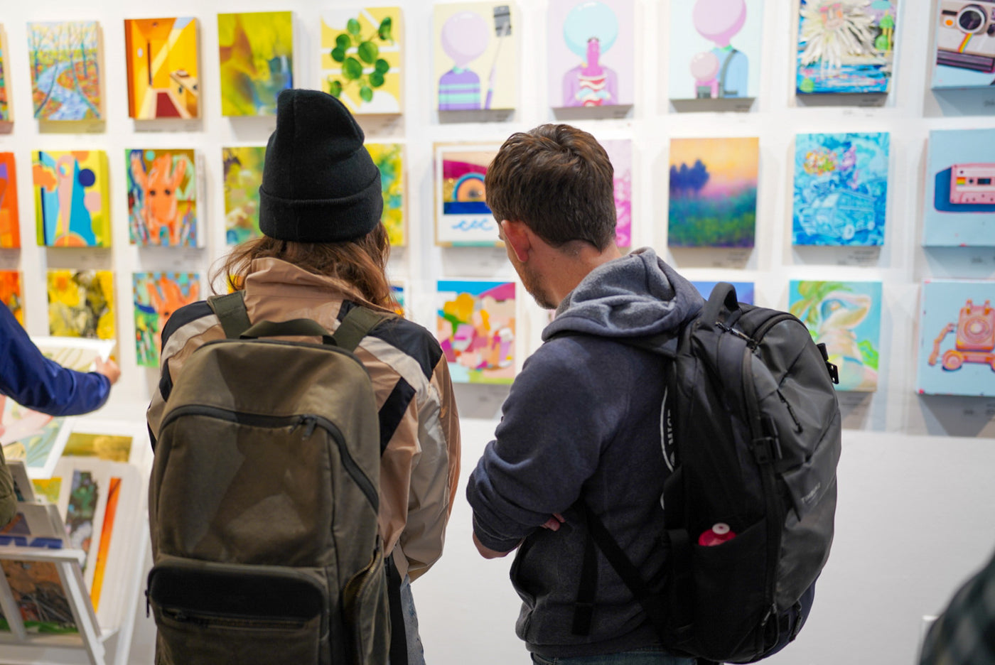 Photograph of two men viewing artwork.